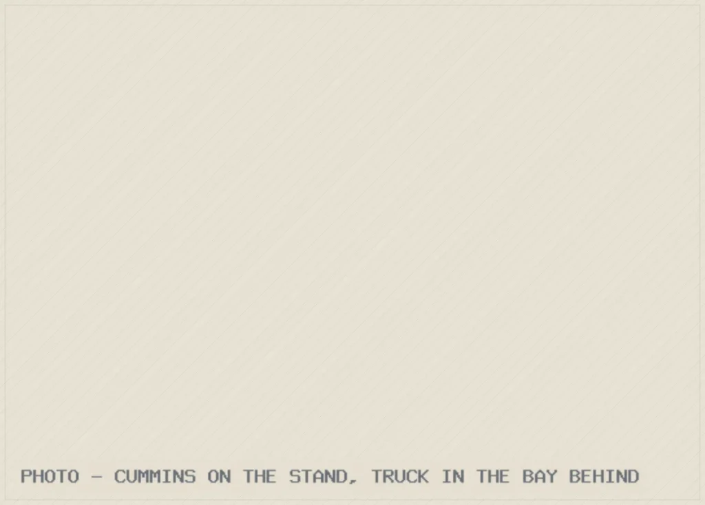 PHOTO - CUMMINS ON THE STAND, TRUCK IN THE BAY BEHIND